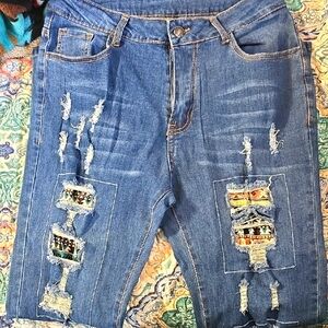 Distressed Blue Denim Jeans with Patterned Patches